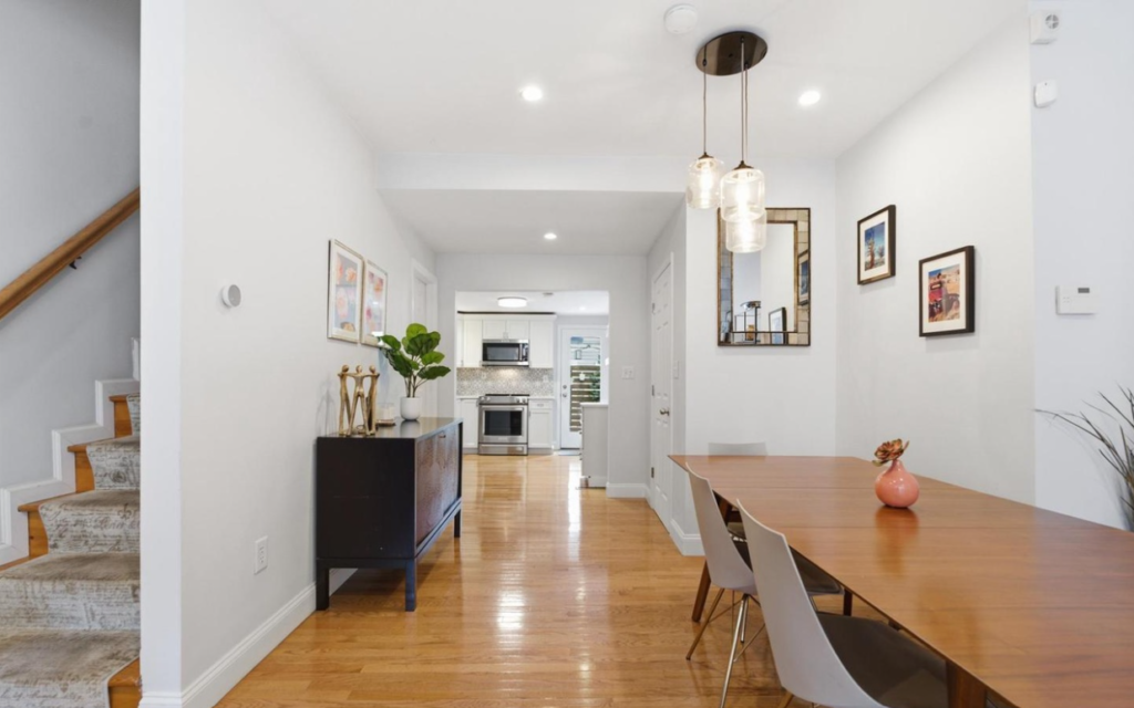 Glossy hardwood flooring installed in the kitchen and dining area